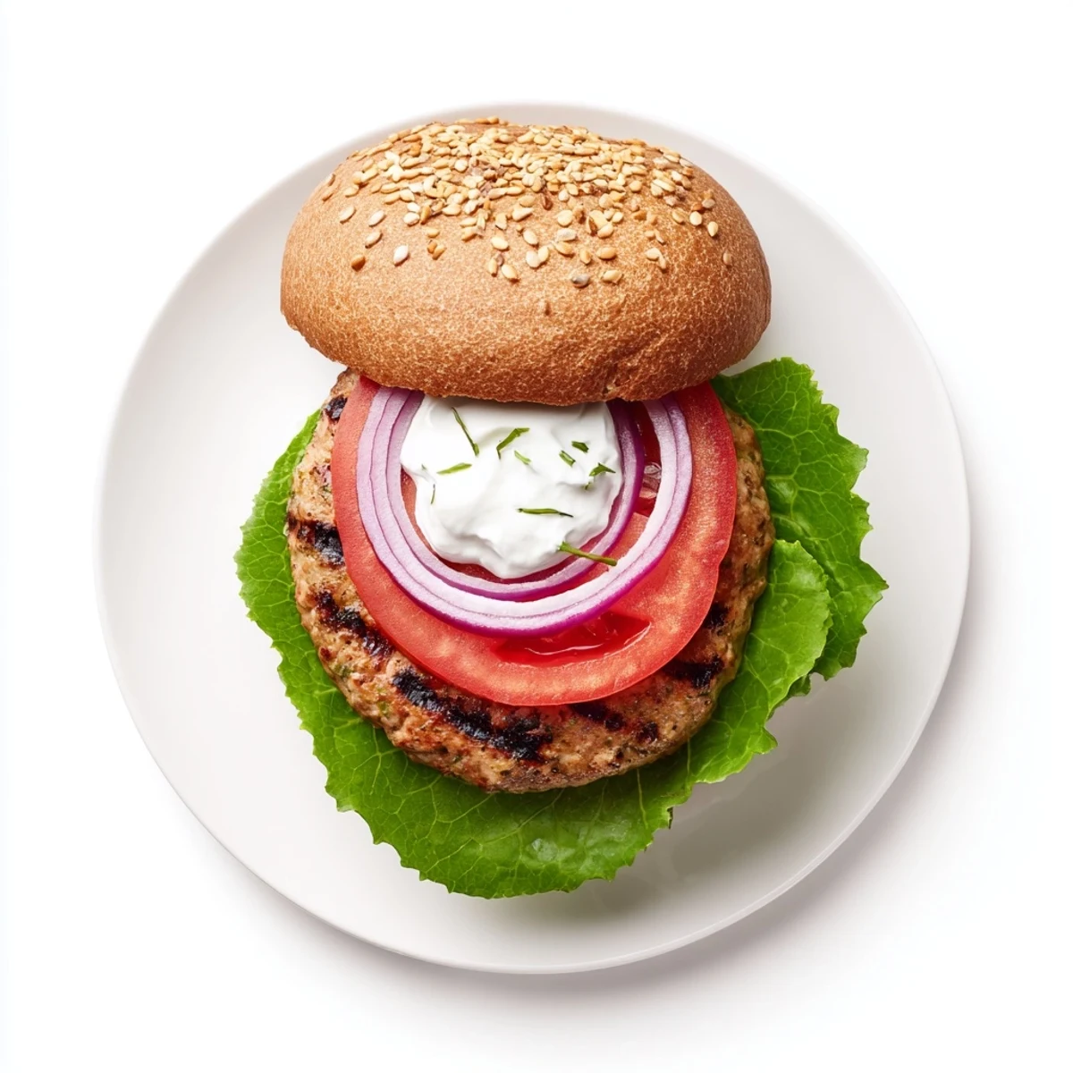 Homemade healthy high protein burger featuring lean turkey patty with colorful red onion and ripe tomato slices