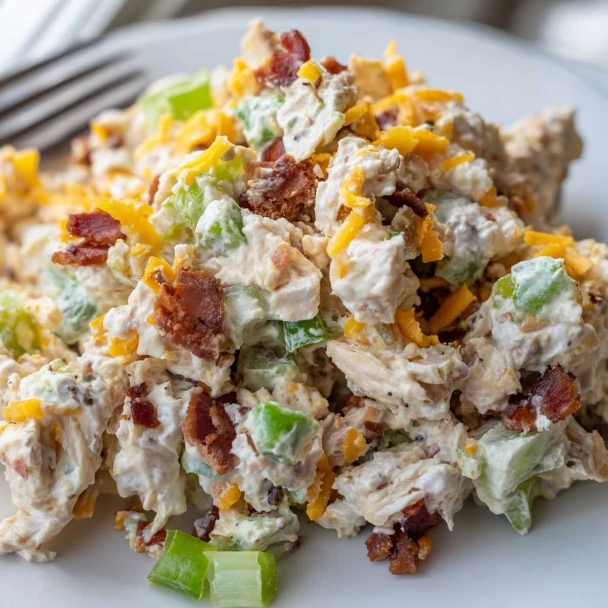 Creamy jalapeno popper keto chicken salad with bacon bits in a white bowl