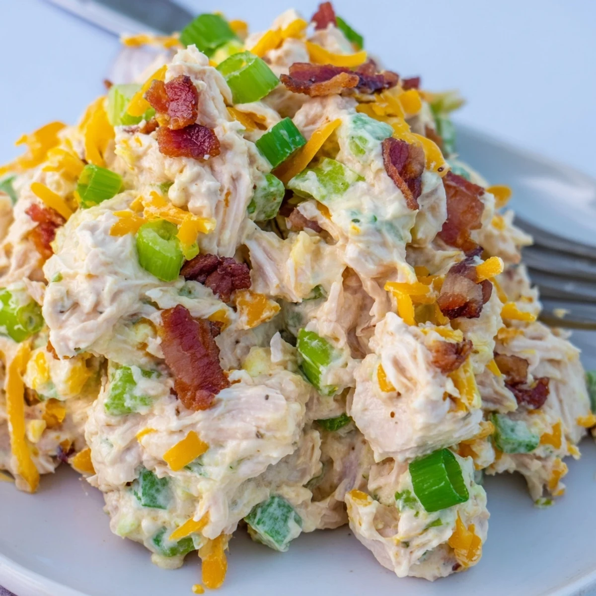 Spicy low-carb chicken salad plated on fresh lettuce with cheddar and jalapenos