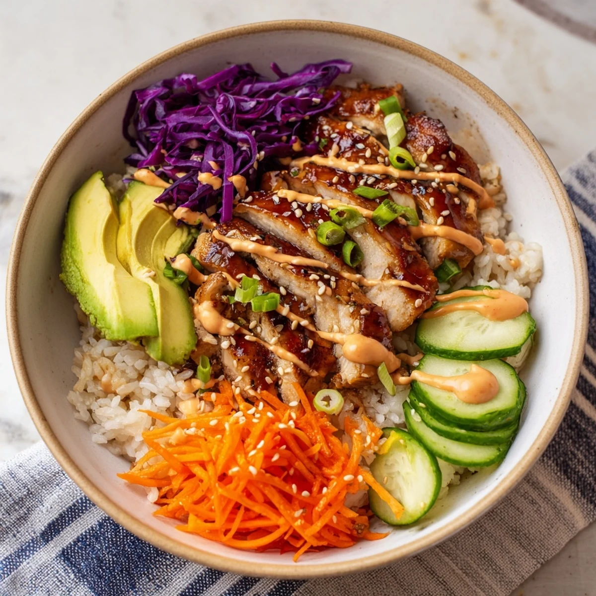 Golden grilled Korean BBQ chicken over rice with colorful vegetables and spicy gochujang mayo drizzle