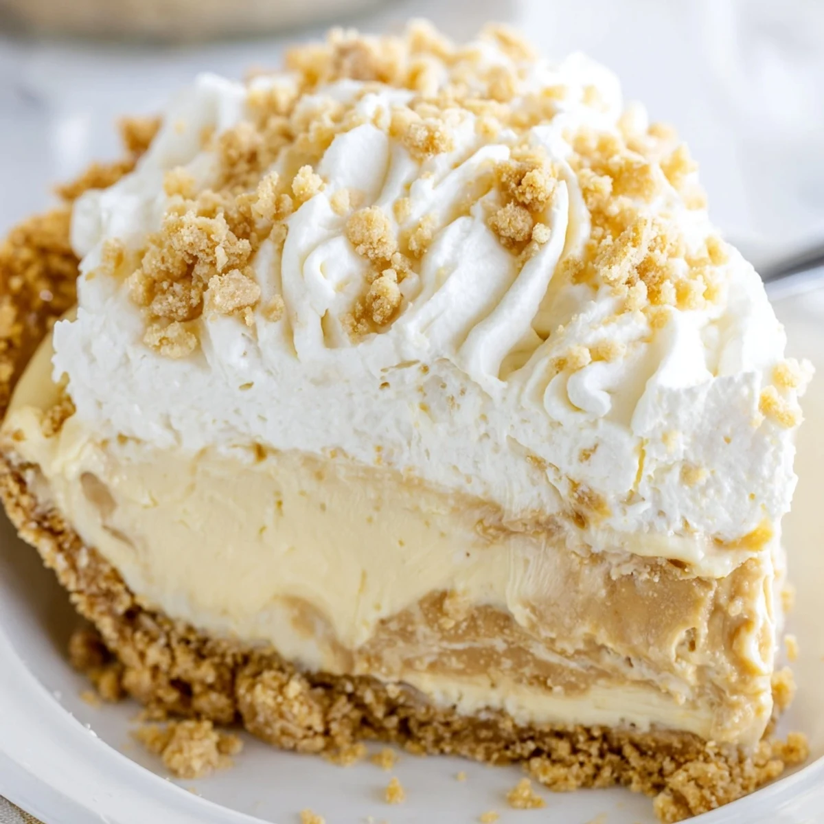 Velvety Old Fashioned Amish Peanut Butter Dream Pie sliced to reveal rich, creamy peanut butter filling