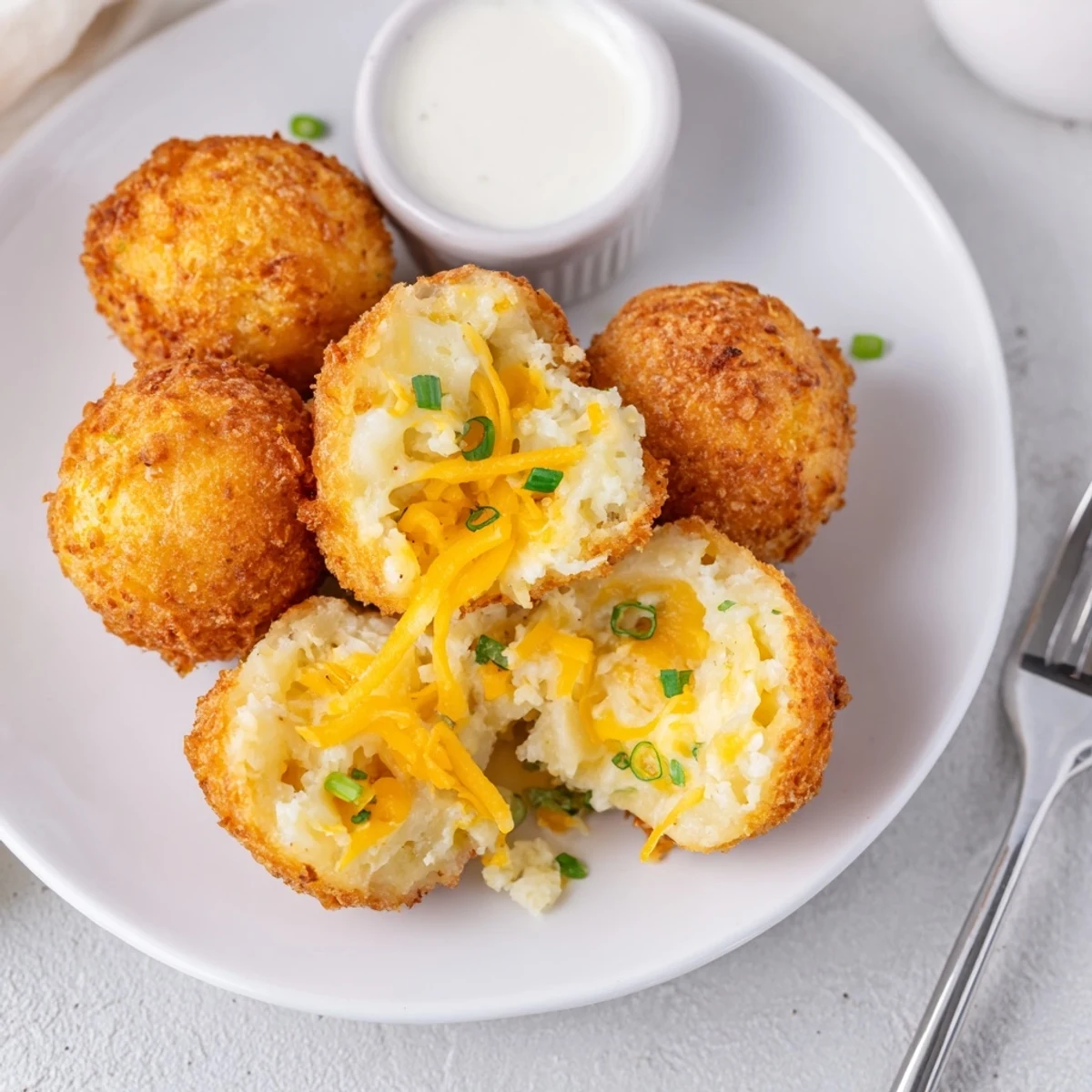 Steaming Fried Mashed Potato Balls with gooey cheddar center and scallions  