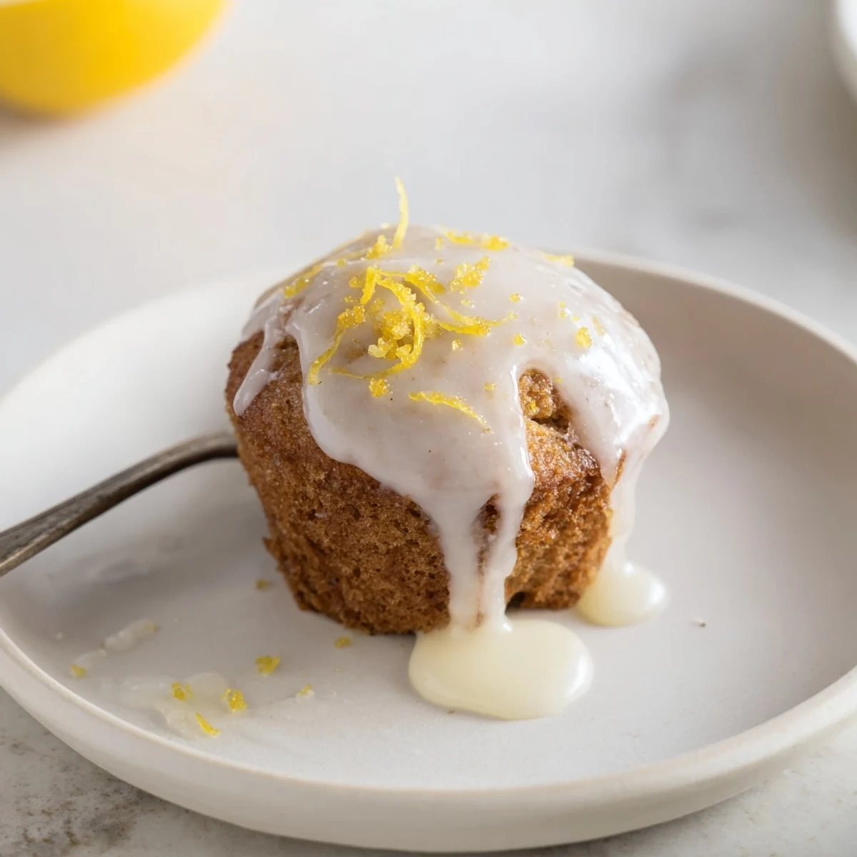 A plate of Glazed Lemon Ginger Muffins, warm, citrus aroma and gingery bite  