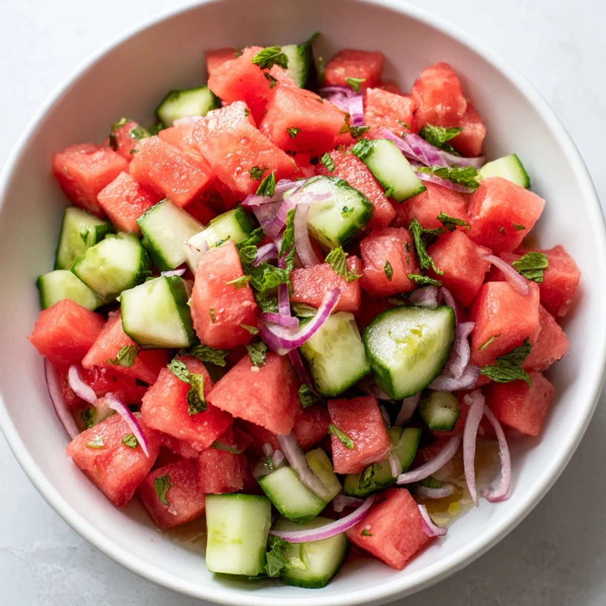 Chilled Watermelon Cucumber Salad tossed with olive oil, lime zest, flaky salt