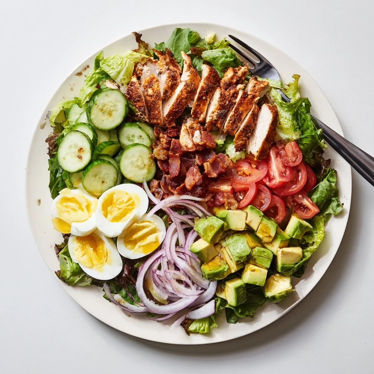 Colorful Paleo Grilled Chicken Cobb Salad layered with fresh vegetables and creamy avocado slices