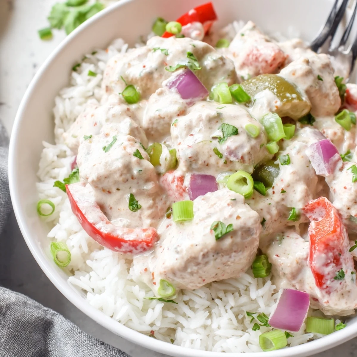 Creamy Cajun chicken rice bowl featuring tender spiced chicken in rich sauce over fluffy white rice