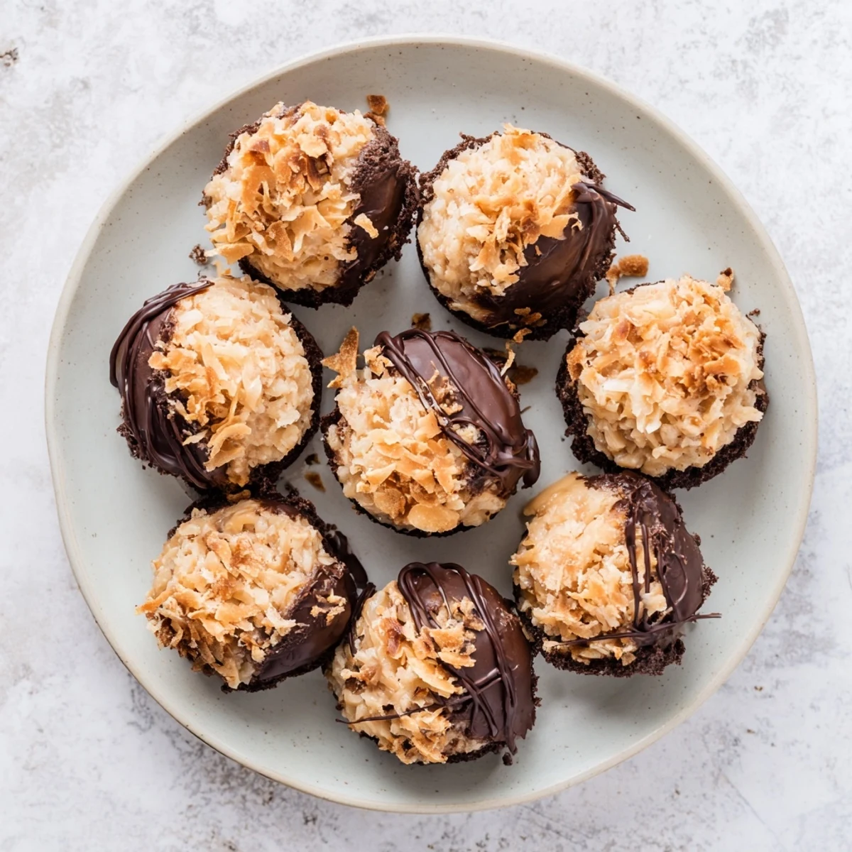 No bake Samoa bites drizzled with melted dark chocolate over toasted coconut and caramel