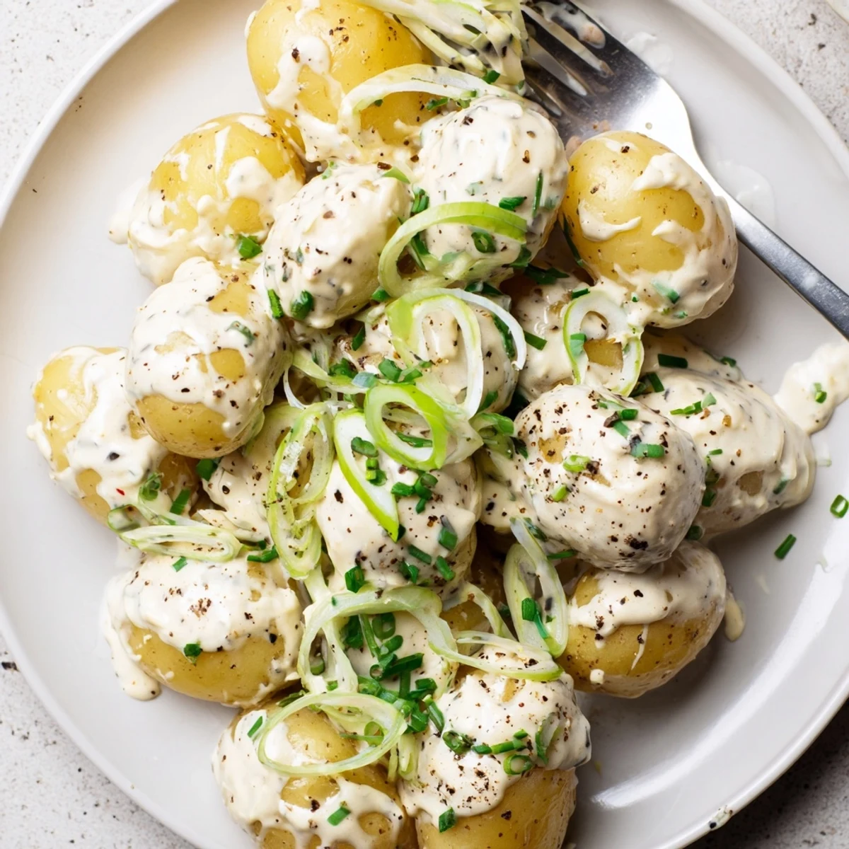 Sour Cream And Onion Potato Salad with chives, creamy tang, picnic-ready bowl