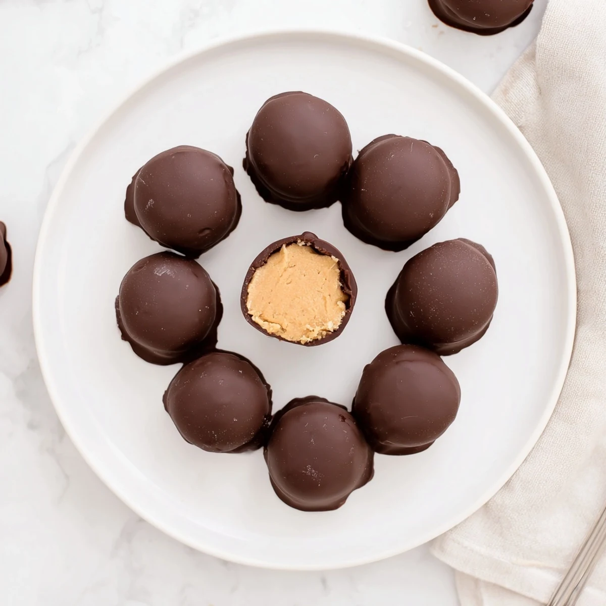 A stack of Homemade Peanut Butter Eggs drizzled with white chocolate, festive
