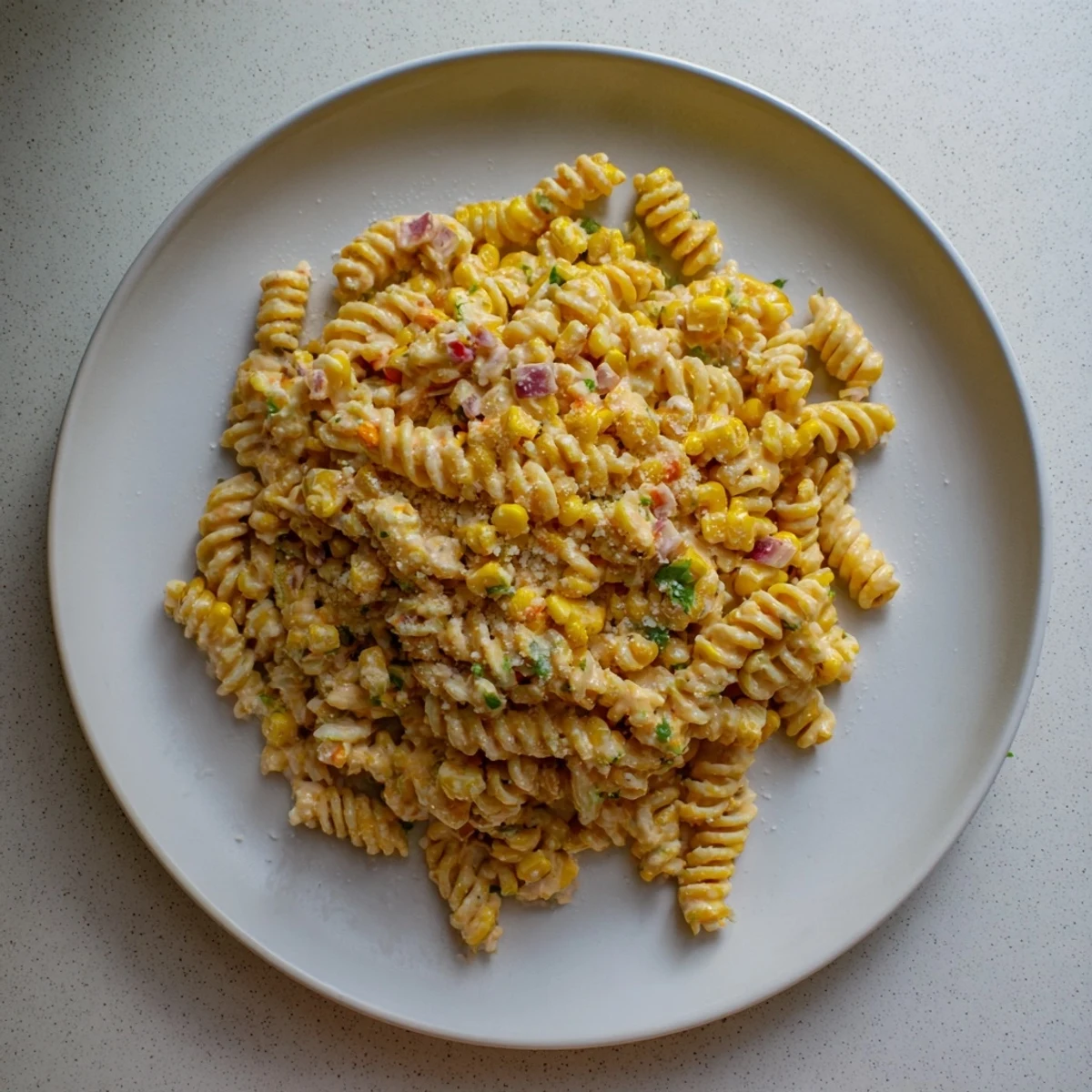 A chilled bowl of Creamy Street Corn Pasta Salad garnished with cilantro