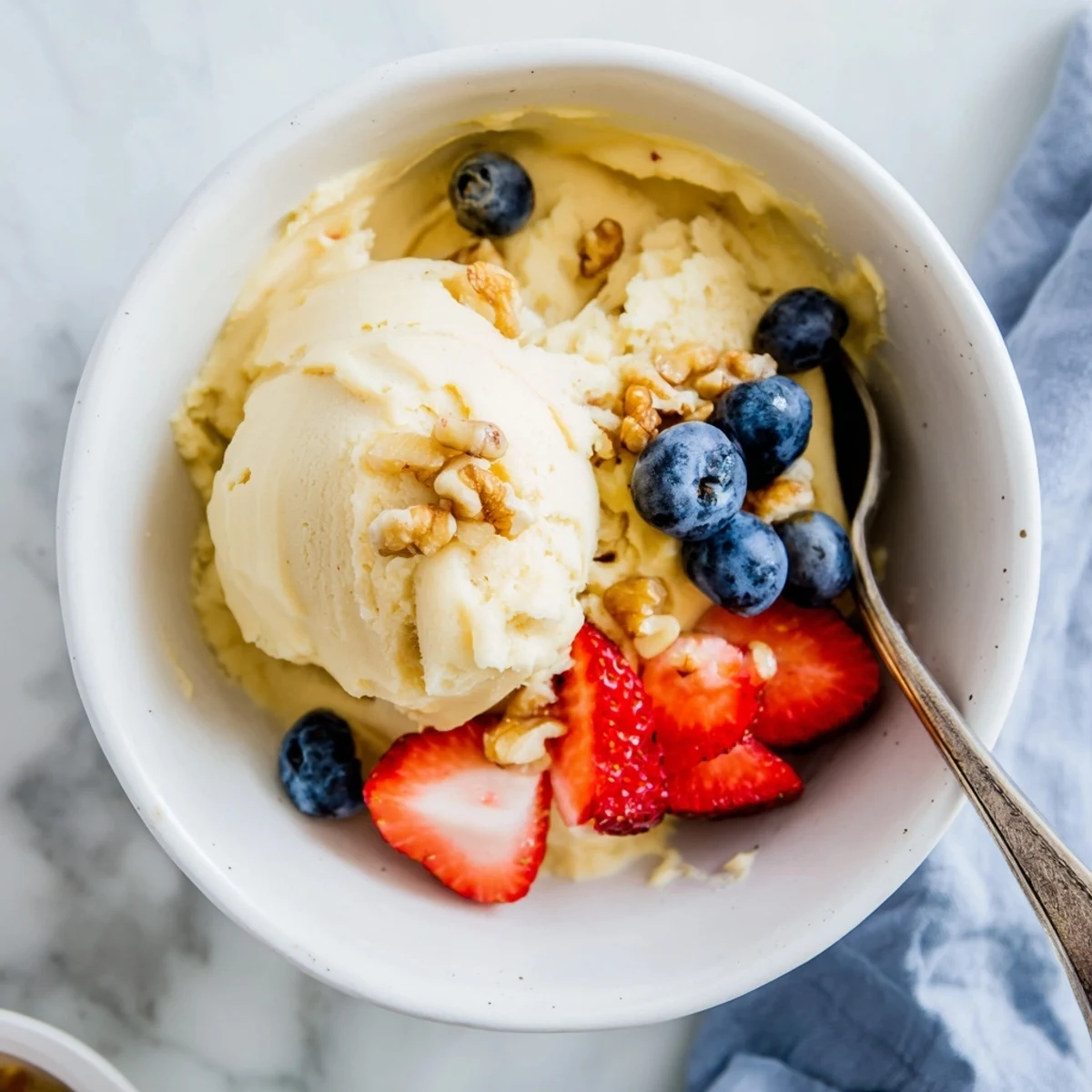 Dairy-free healthy nice cream recipe served soft and creamy with colorful berry toppings and cacao nibs