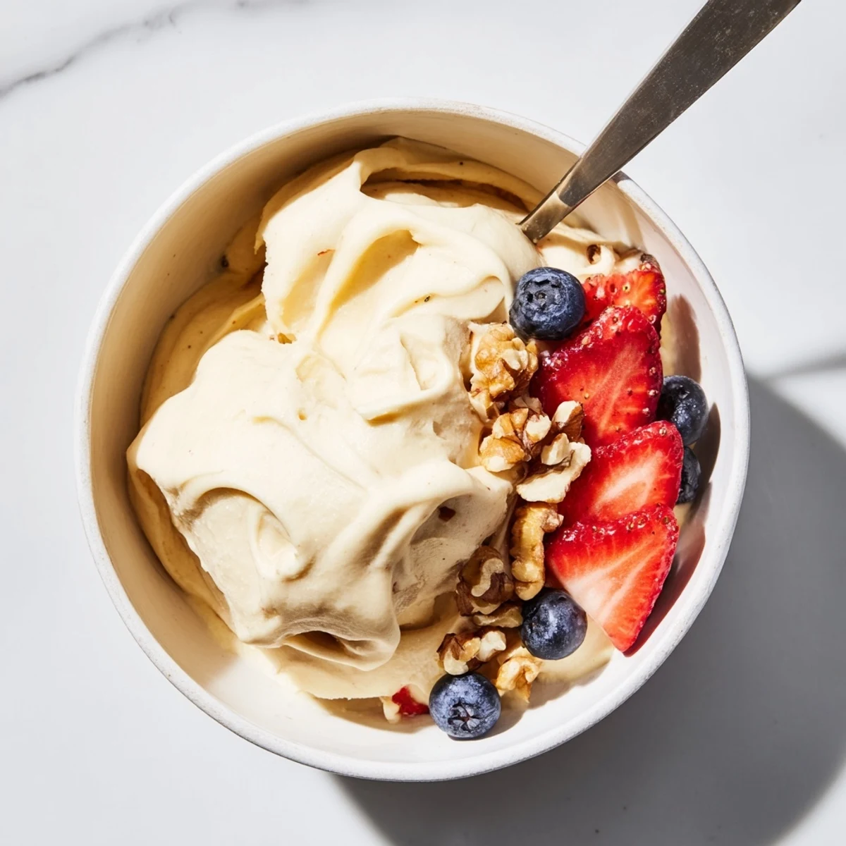 Vegan healthy nice cream recipe blended from frozen bananas with optional cocoa powder and vanilla swirls