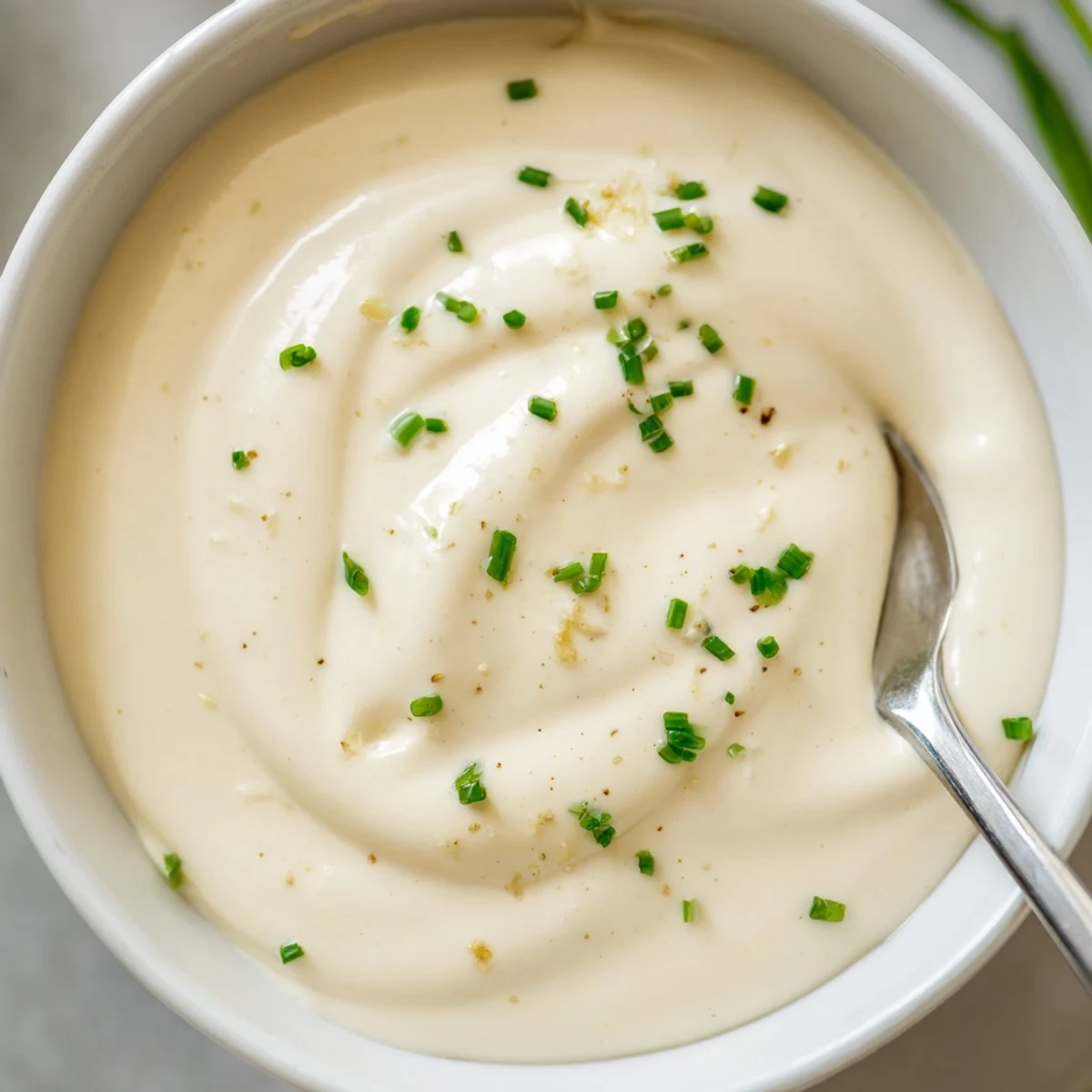Creamy Tangy Sauce in a bowl, silky texture, lemon wedge garnish  