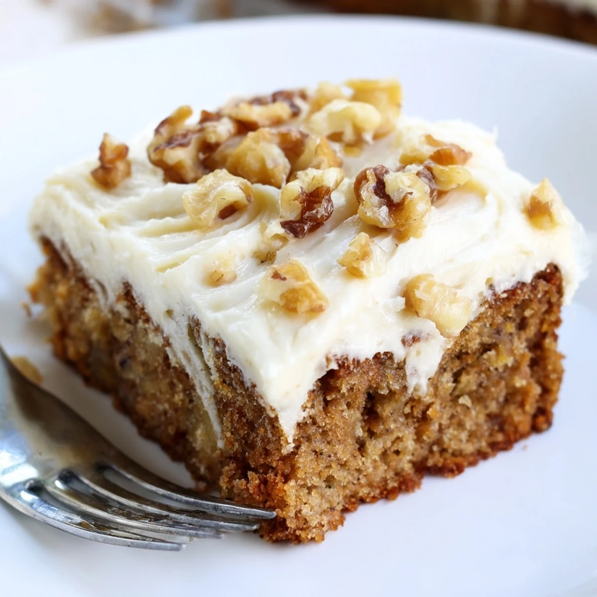 Moist Banana Cake with golden crumb and sliced bananas, served with coffee