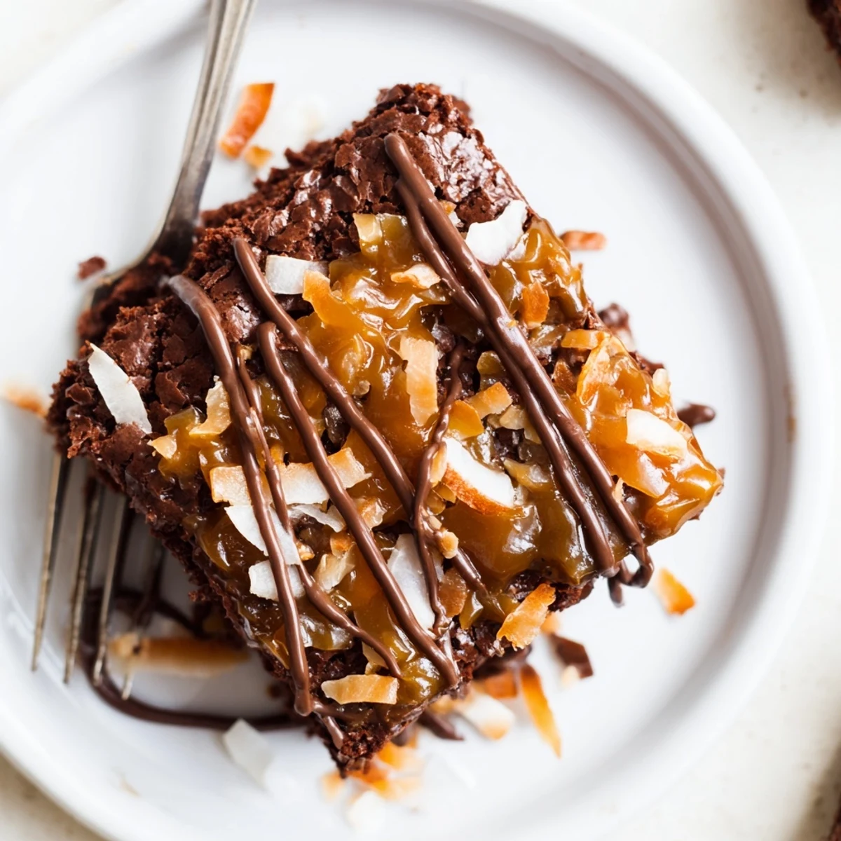Rich Samoa Brownies topped with glossy caramel, golden toasted coconut, fudgy interior