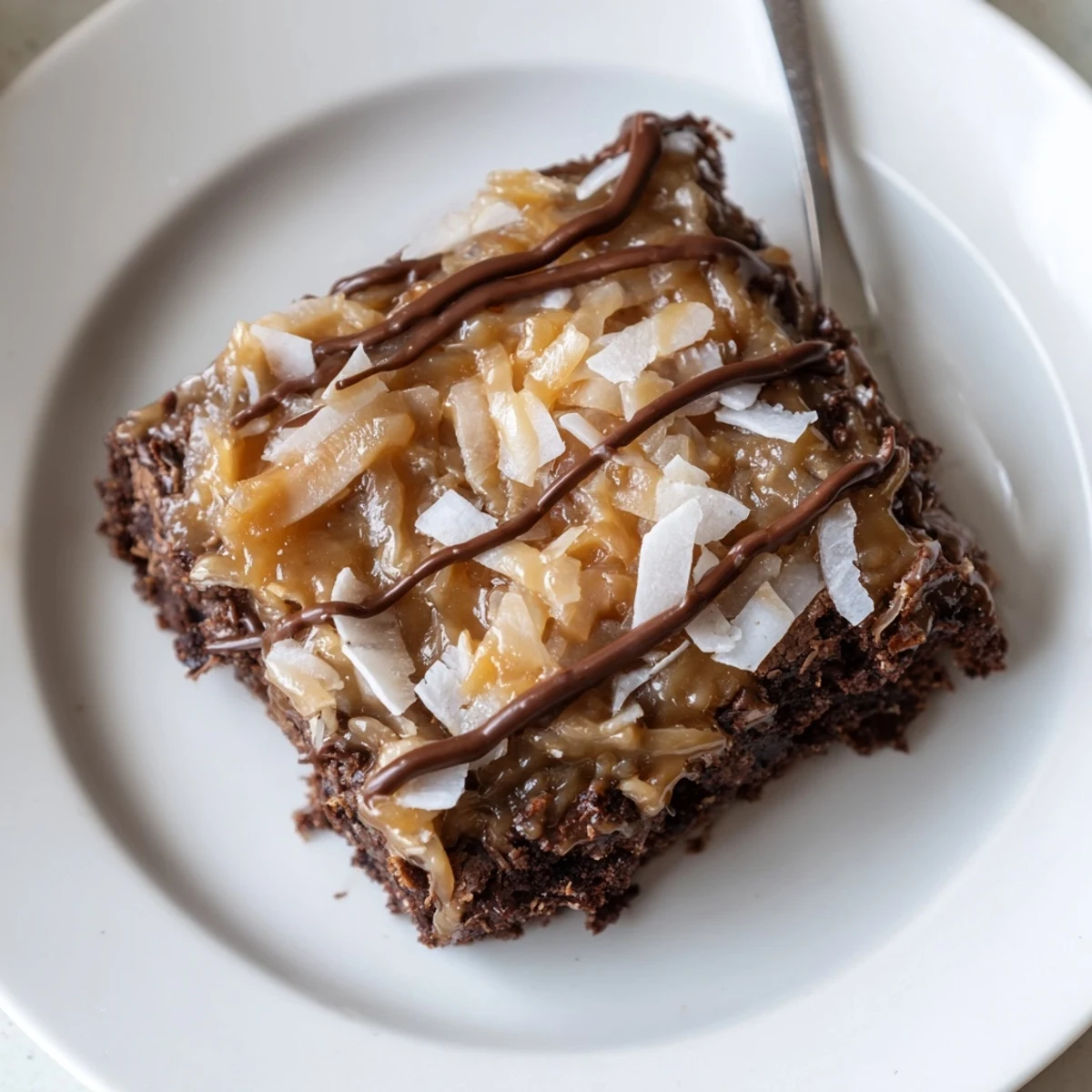 Samoa Brownies sliced into squares, dark chocolate drizzle and coconut-scented aroma