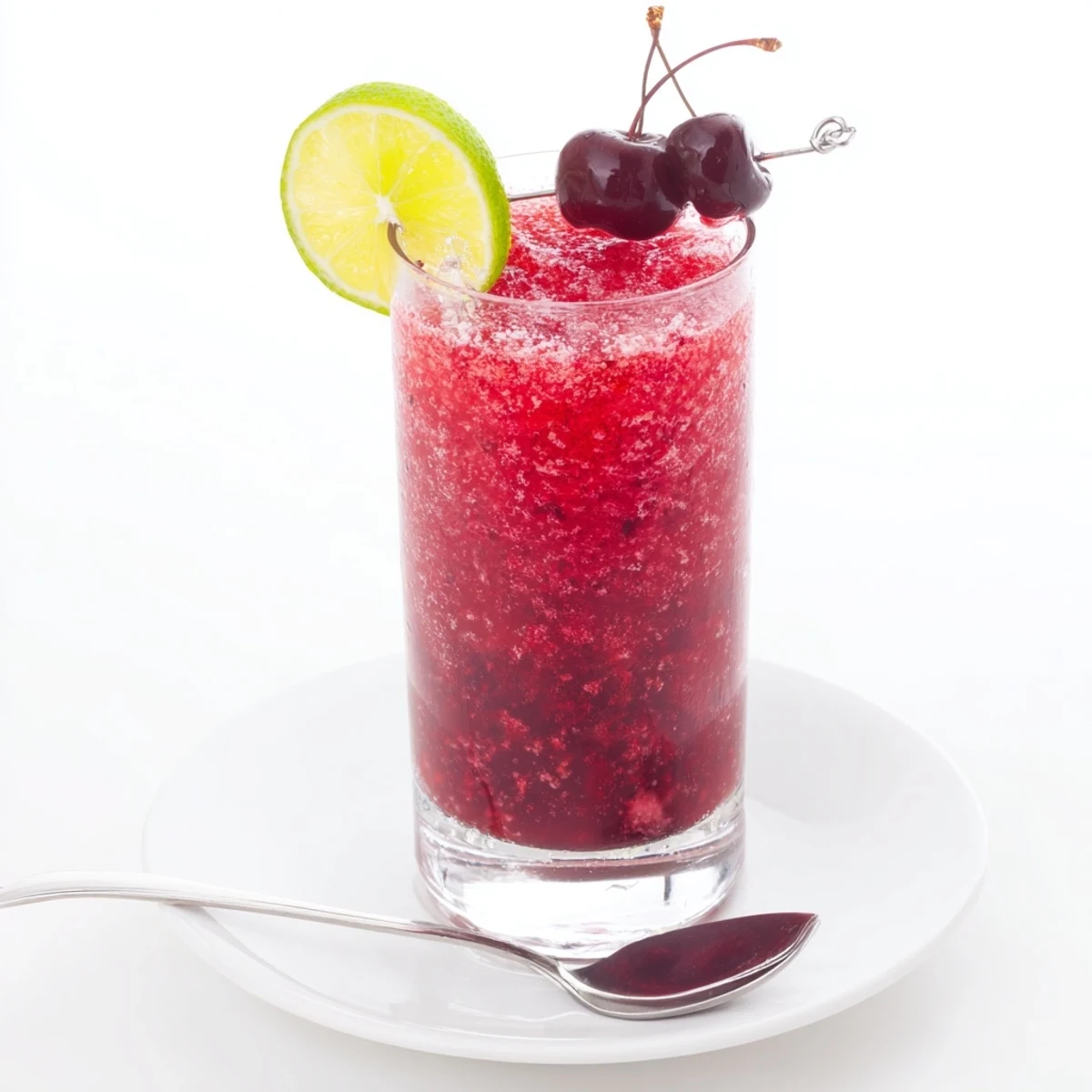 Refreshing Cherry Lime Sunrise Slush poured into chilled glasses, garnished with lime.