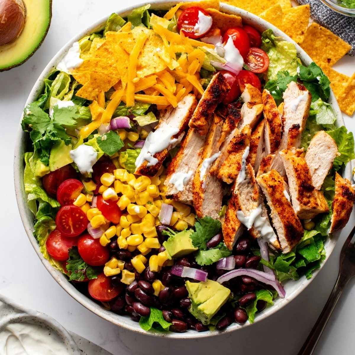 Rustic wooden serving board featuring layered Southwestern chicken salad with fresh romaine, crisp vegetables, and zesty lime dressing
