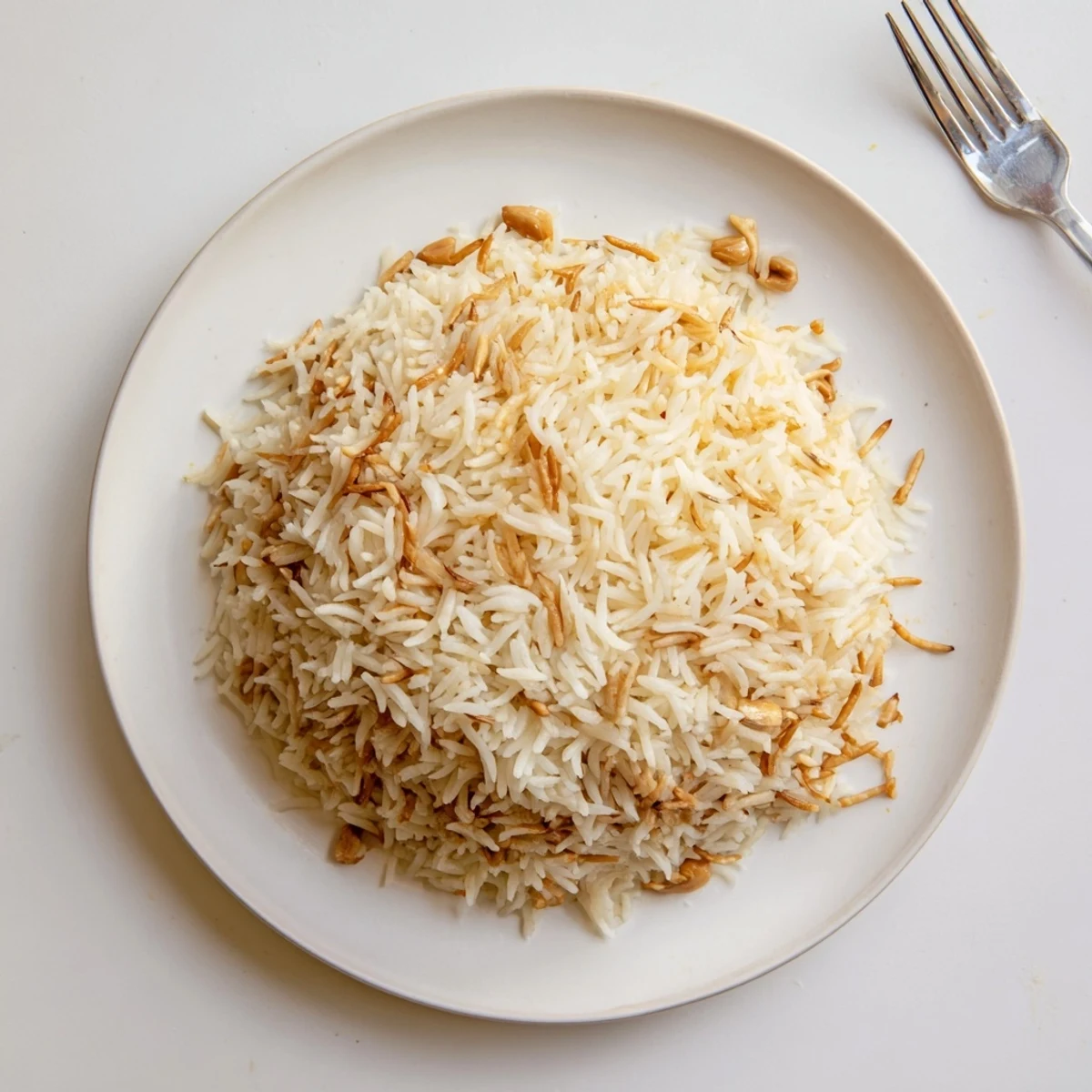 Steaming plate of Lebanese Rice topped with buttery vermicelli beside grilled chicken