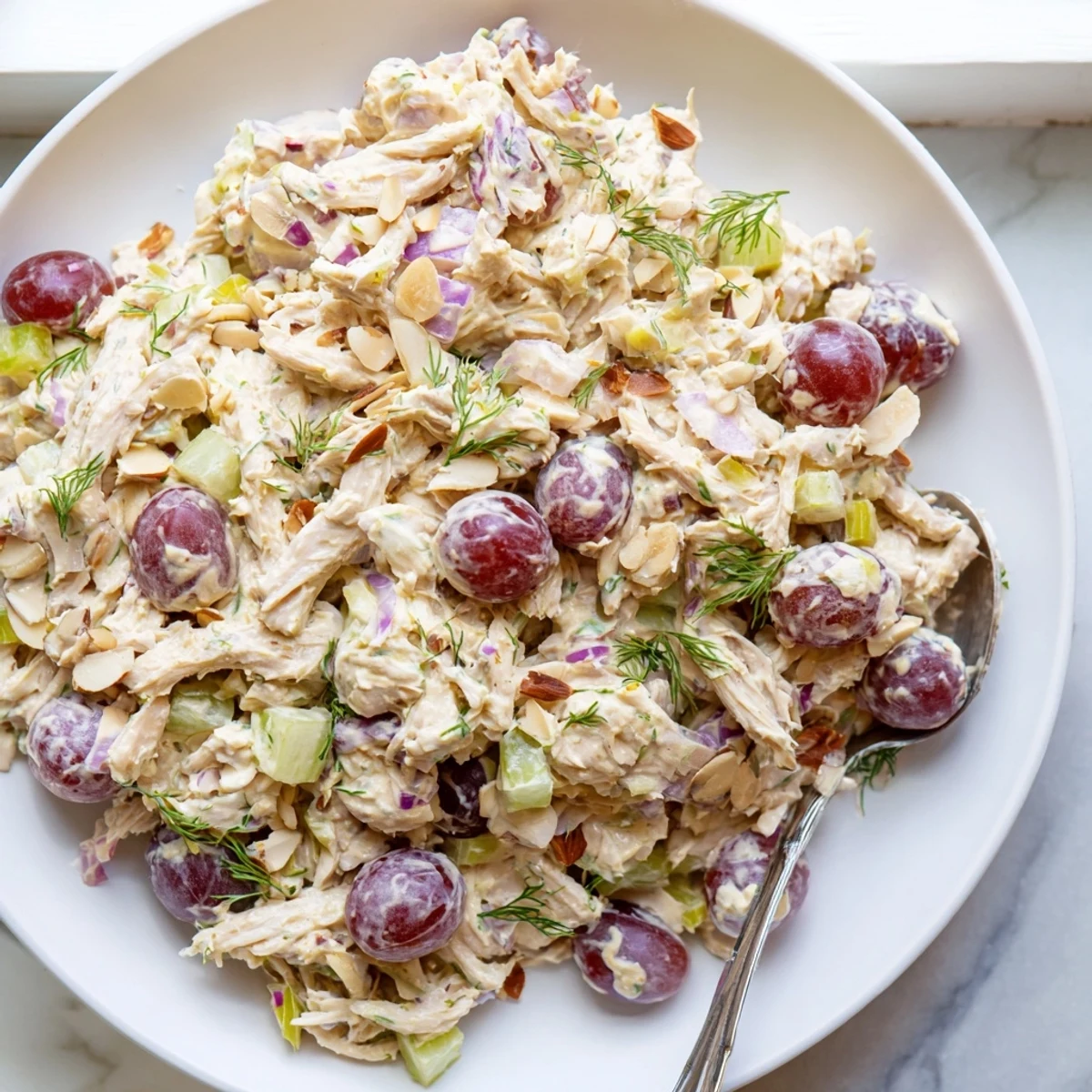 Creamy vegan chicken salad piled high on toasted whole grain bread slices