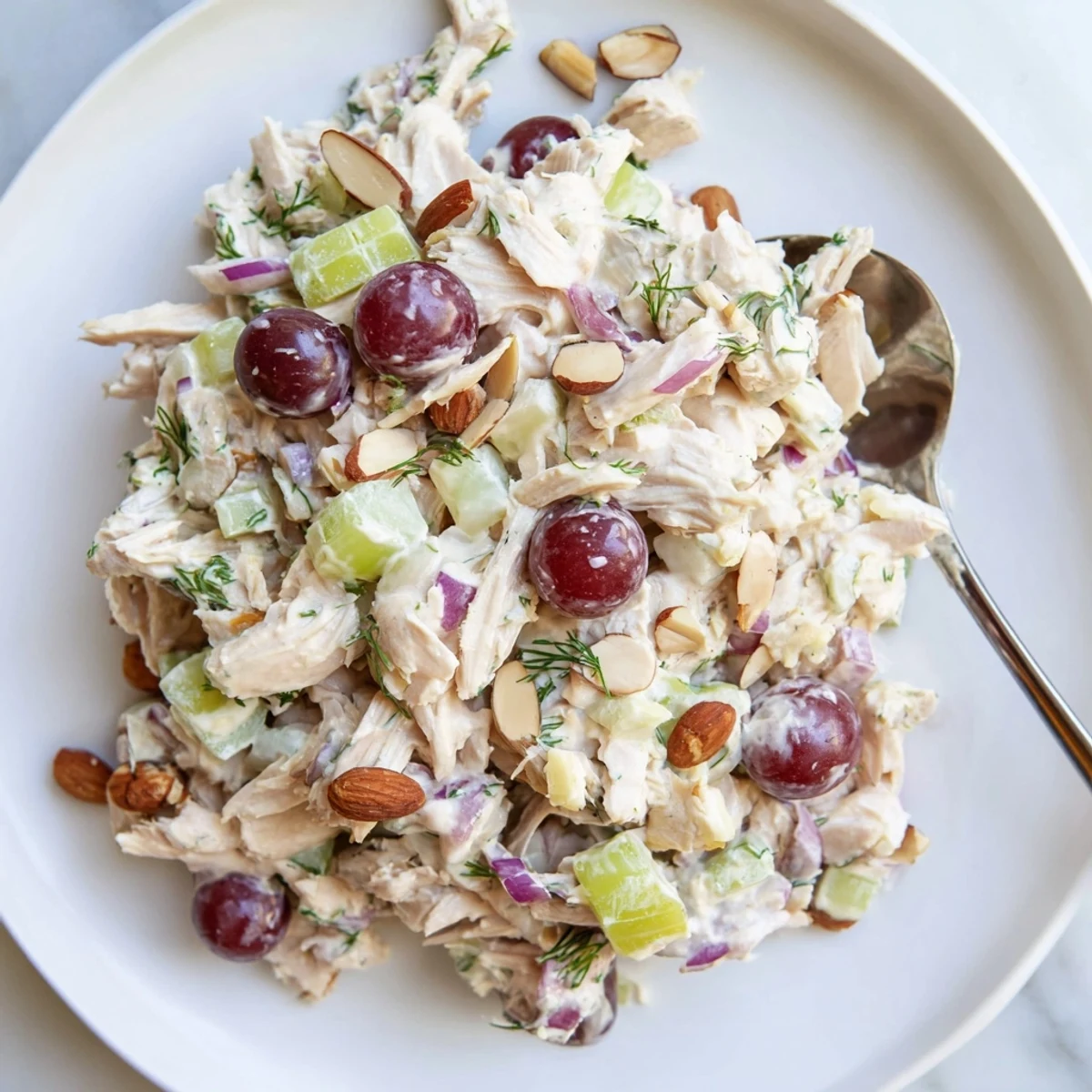 Vibrant vegan chicken salad scooped over crisp lettuce with juicy red grapes