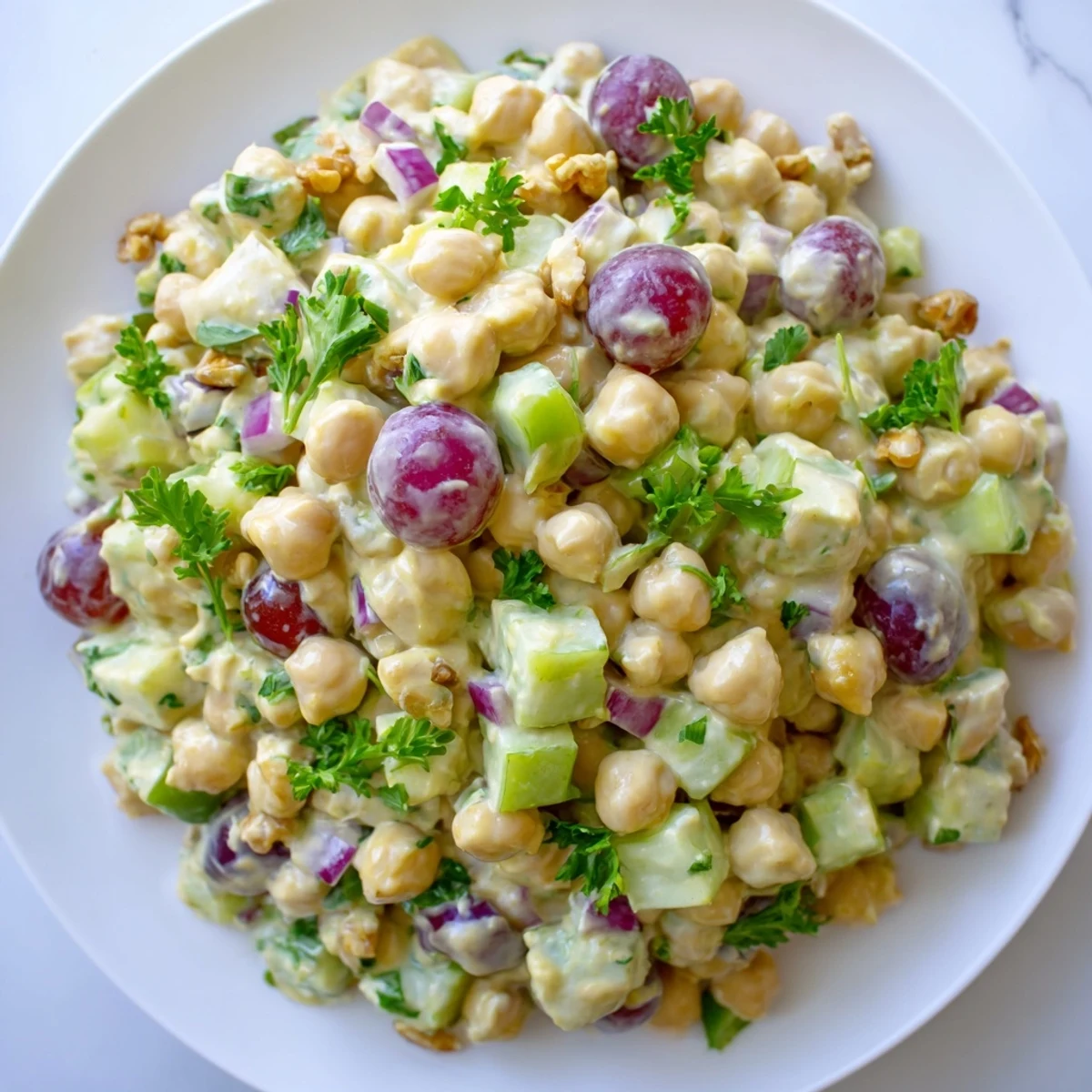Bowl of vegan chicken salad studded with colorful vegetables and creamy dressing
