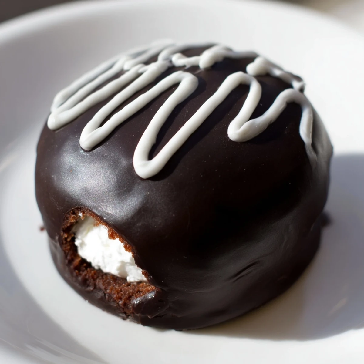 Homemade Hostess Cupcakes with glossy chocolate ganache and pillowy marshmallow filling