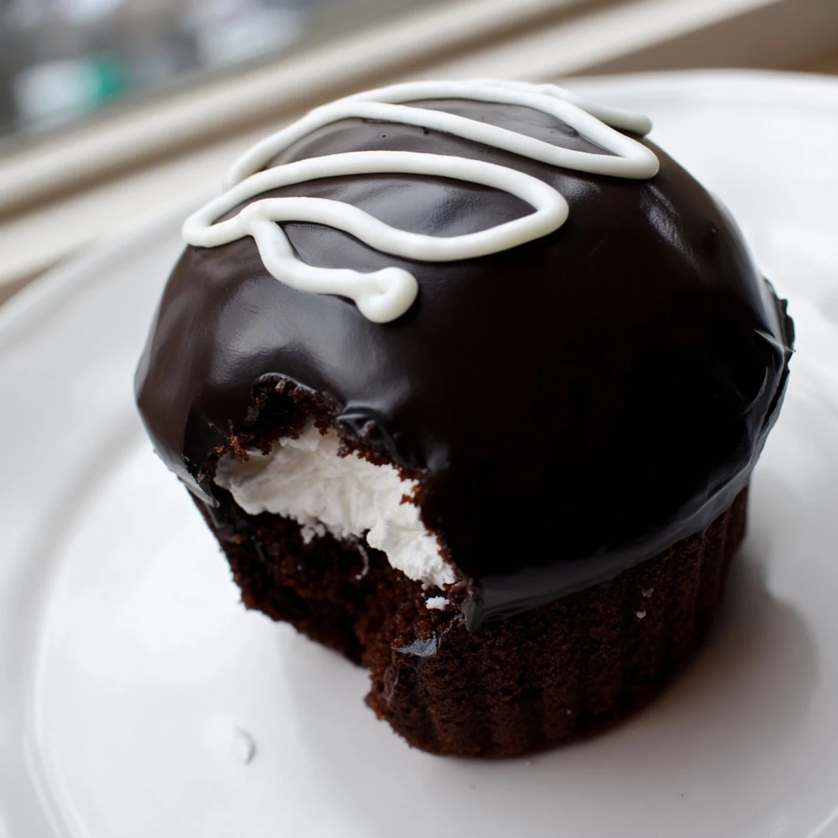 Golden-lined tray of Homemade Hostess Cupcakes topped with creamy marshmallow centers