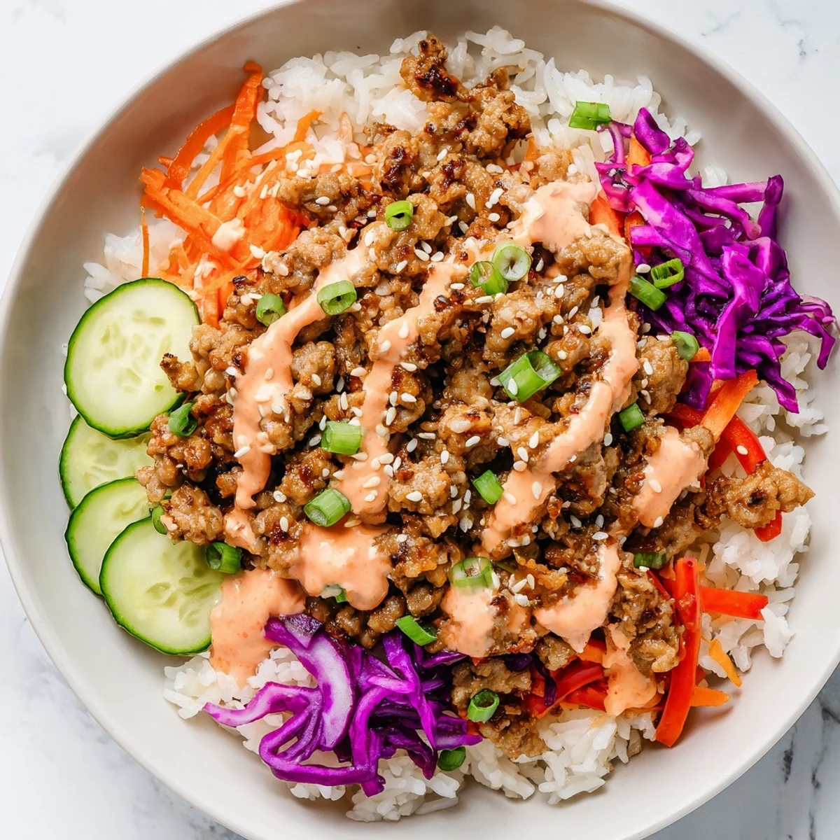 Hearty ground turkey rice bowls drizzled with creamy, spicy Bang Bang sauce and crisp vegetables.
