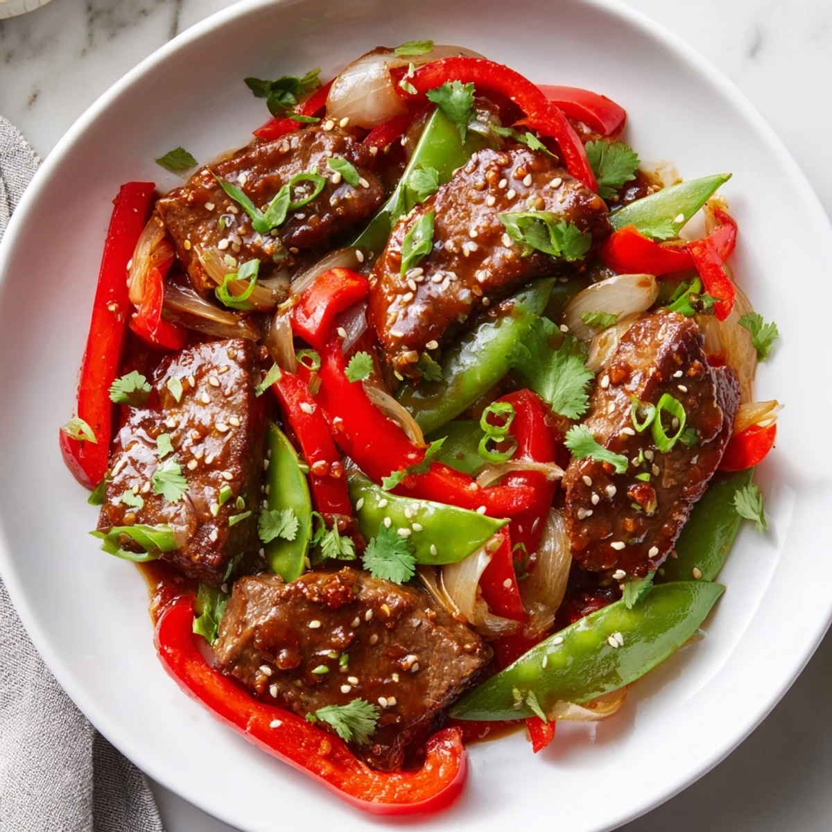 Tender Asian-inspired cube steak glazed in soy ginger sauce with crisp stir-fried vegetables