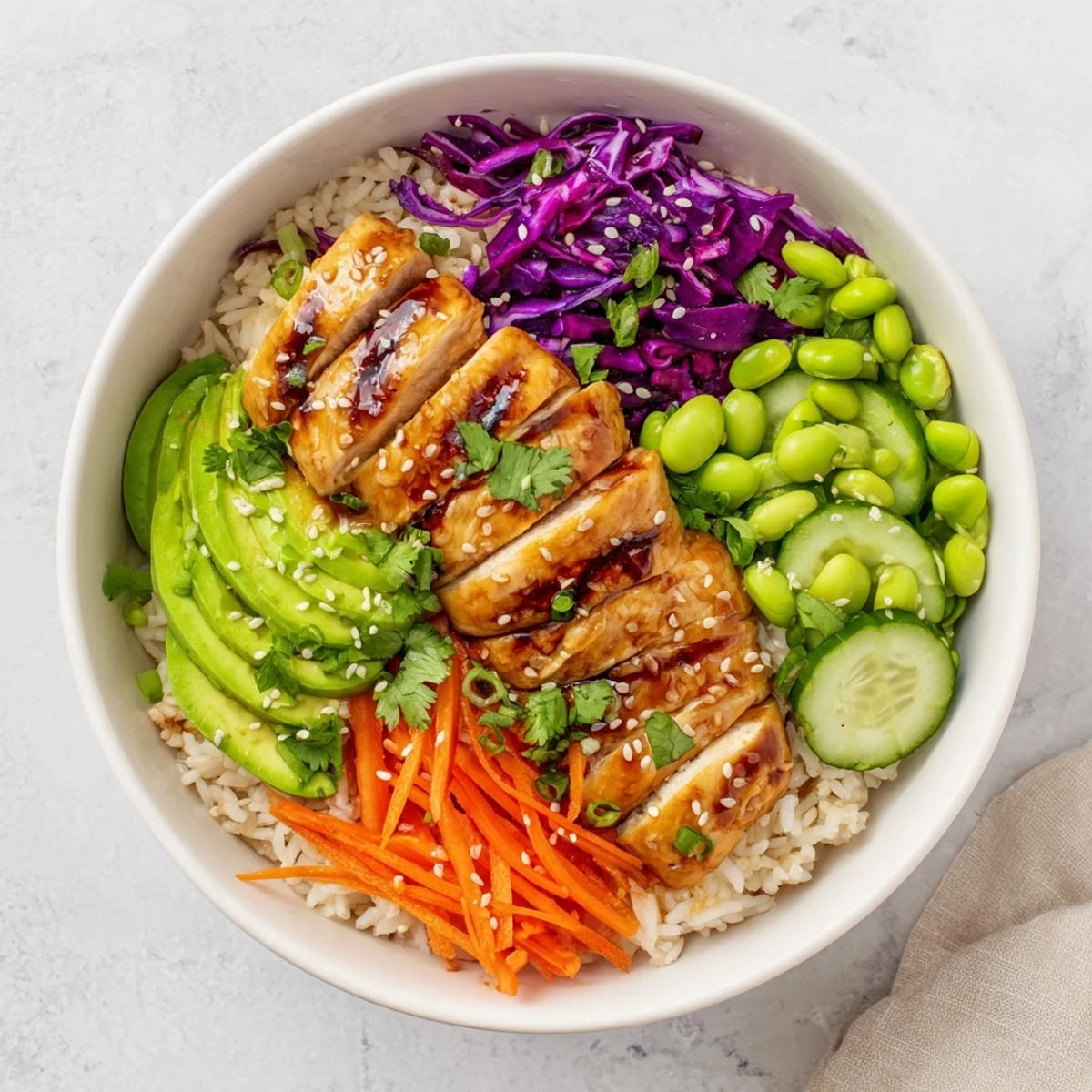 Colorful Asian Inspired Chicken Power Bowl with fresh vegetables and sesame-ginger dressing