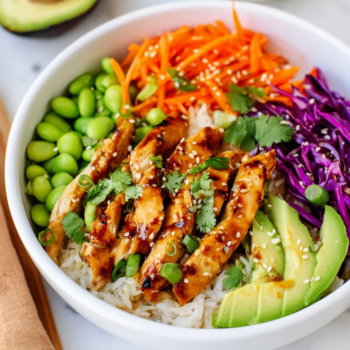 Golden marinated chicken strips served over rice with crisp cabbage and creamy avocado