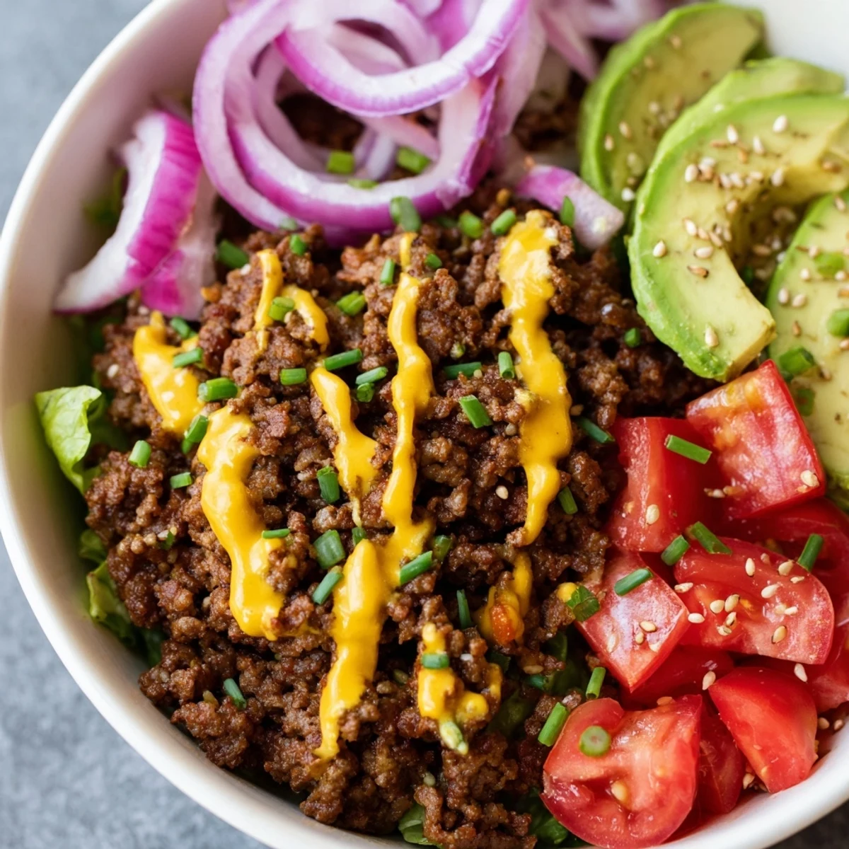 Juicy burger bowls loaded with seasoned beef, melted cheddar, and fresh vegetables