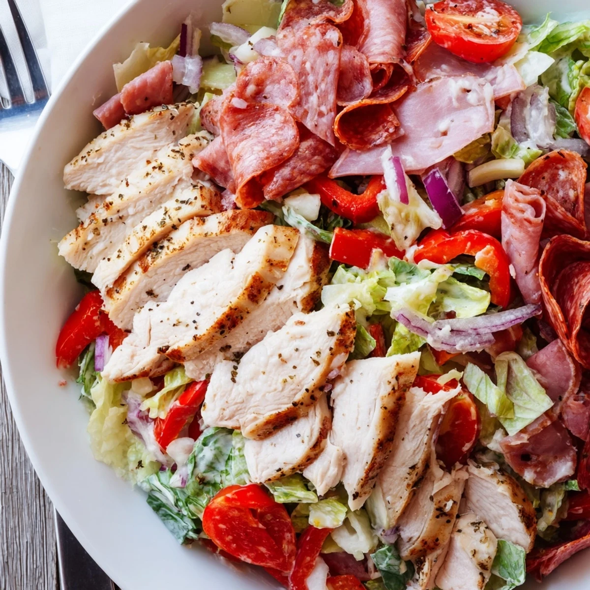 Italian Grinder Chicken Salad topped with sliced deli meats and creamy dressing