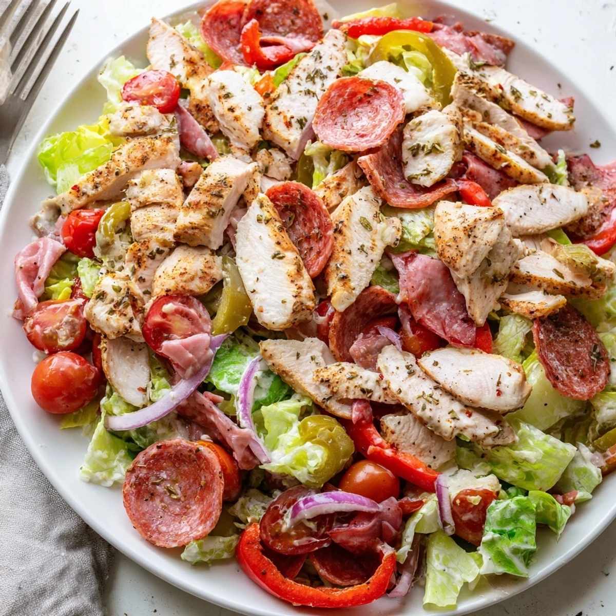 Crisp romaine loaded with Italian Grinder Chicken Salad pepperoncini and melted provolone