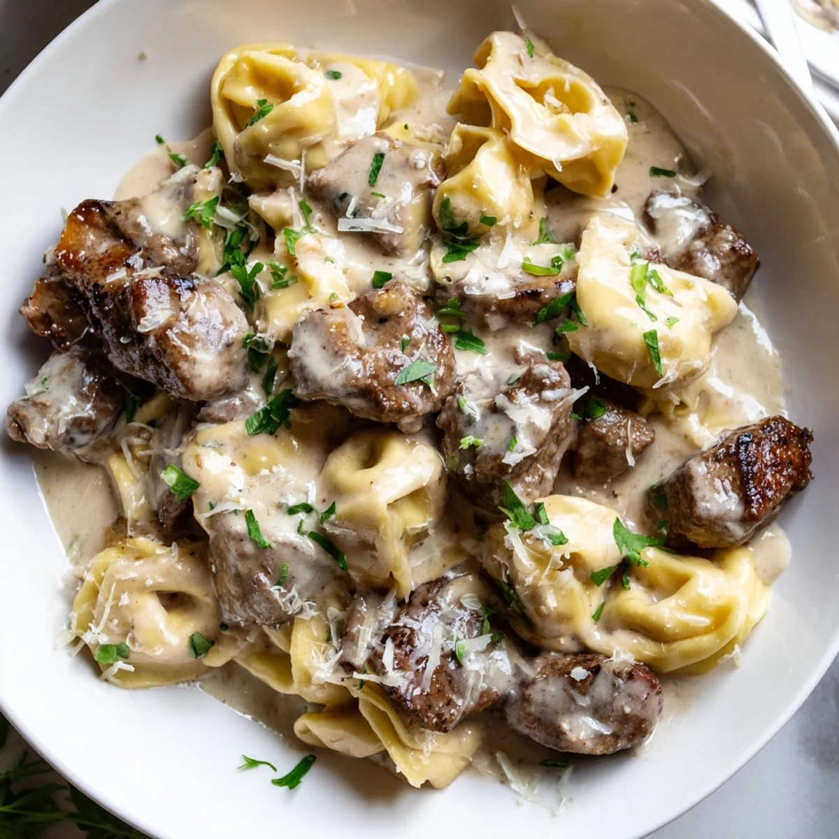 Golden seared steak bites mingled with cheese tortellini in a silky garlic cream sauce