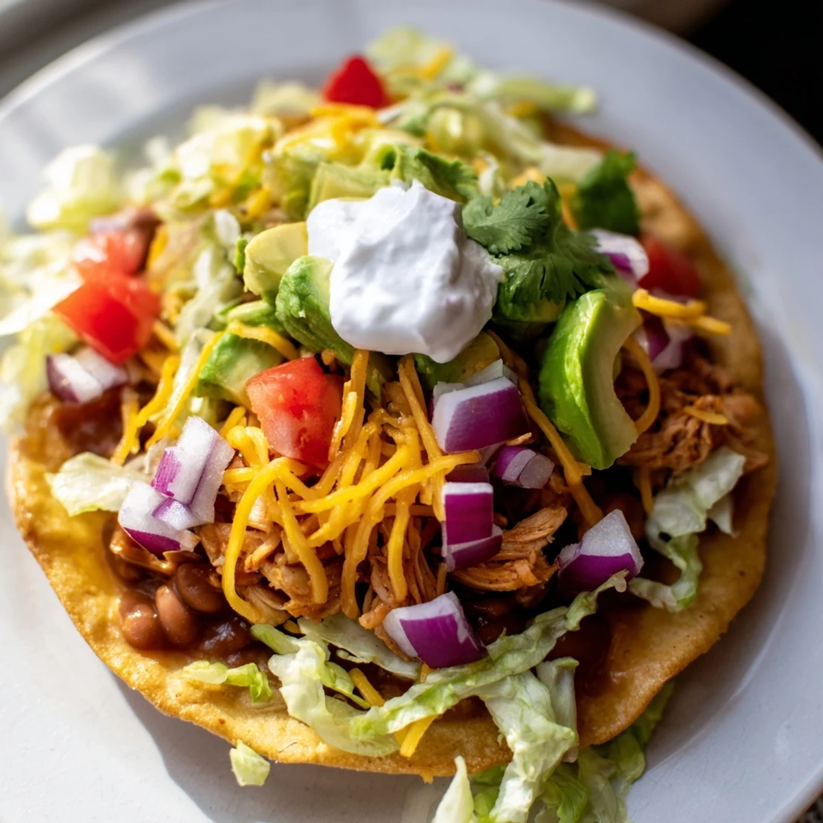 Delicious Chicken Tostadas recipe featuring crunchy shells, seasoned meat, and colorful toppings.
