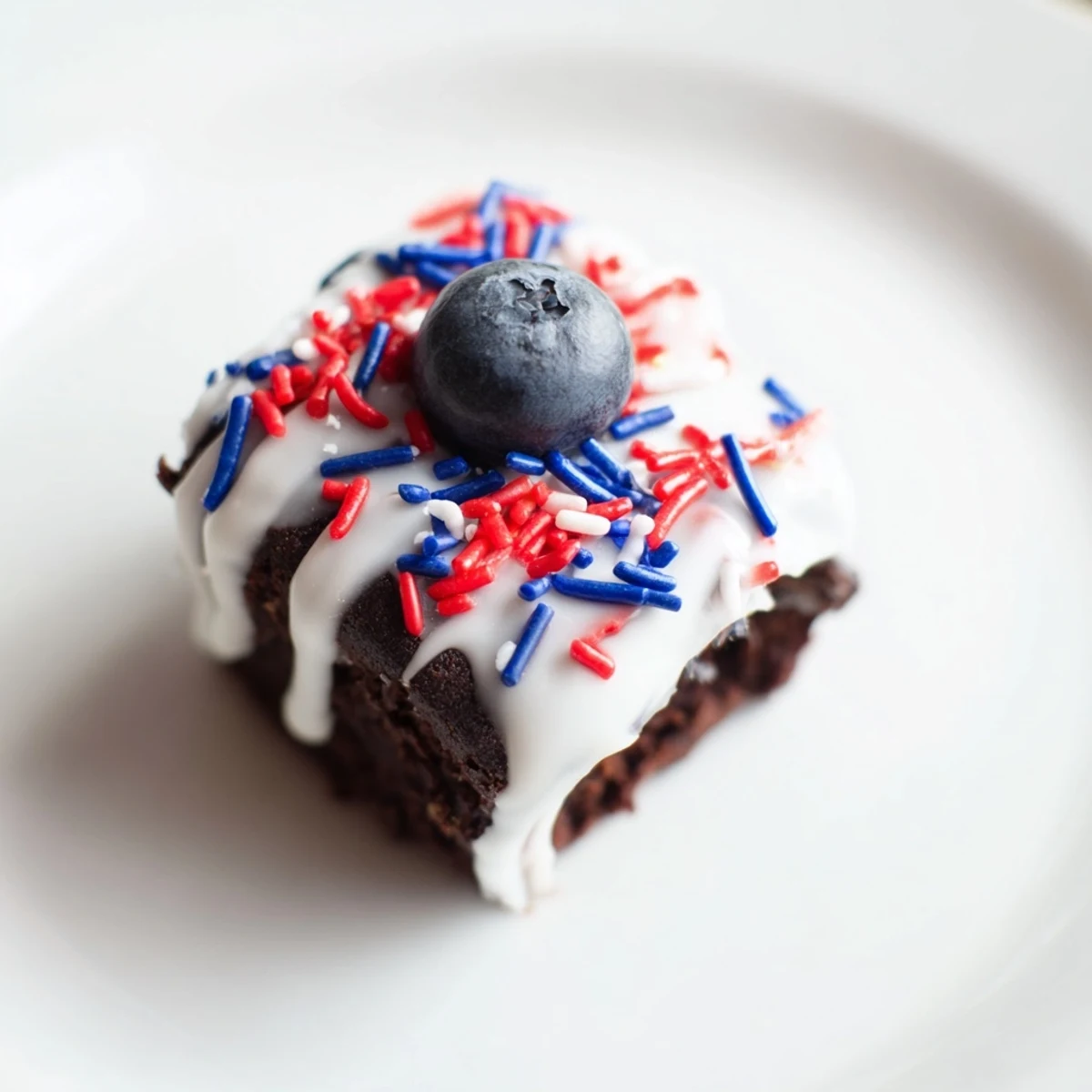 Festive Fourth of July brownie bites topped with red and blue sprinkles.