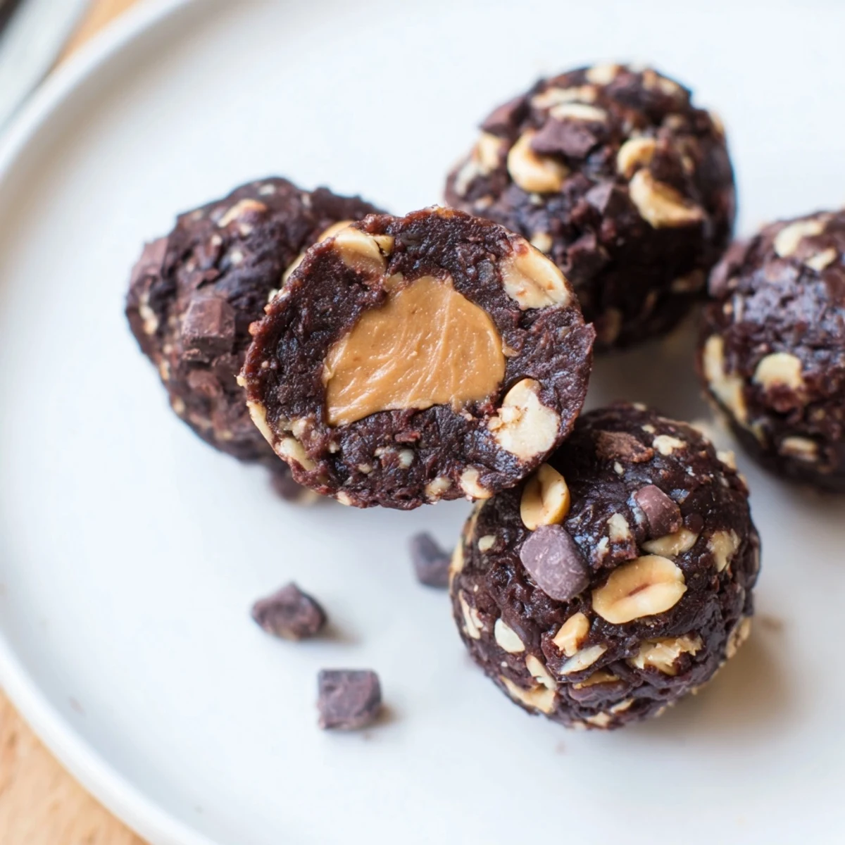 No-bake Snickers energy balls topped with sea salt for a sweet and salty snack.