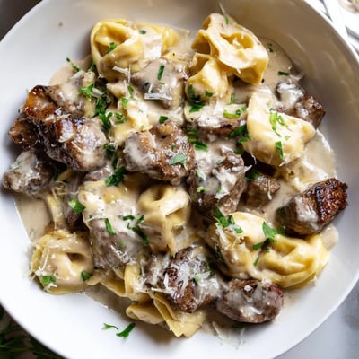 Golden seared steak bites mingled with cheese tortellini in a silky garlic cream sauce