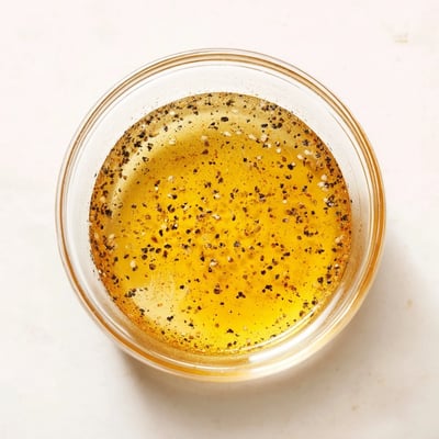 Whisked honey vinaigrette dressing in a glass jar ready for serving.  
